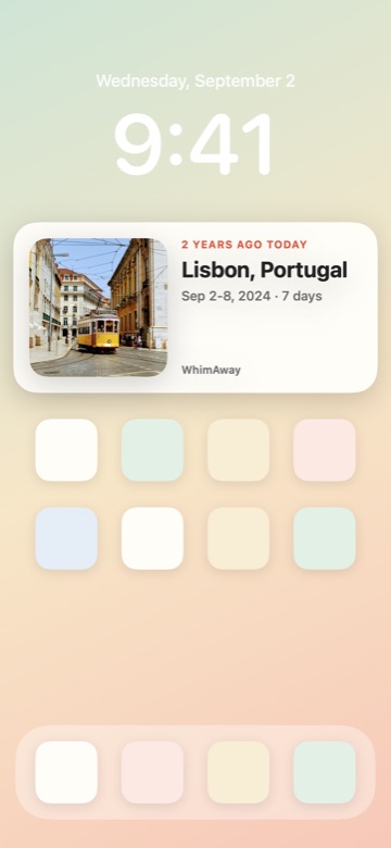 An iPhone home screen with a WhimAway widget reading 2 years ago today, Lisbon, Portugal, with a photo of a yellow tram.